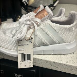 Women’s white adidas sneakers
